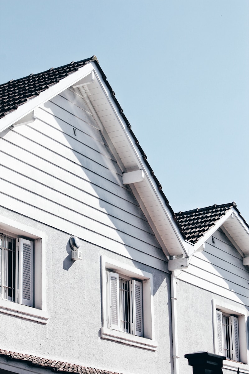 wooden house during day with homeowners insurance to protect their roof